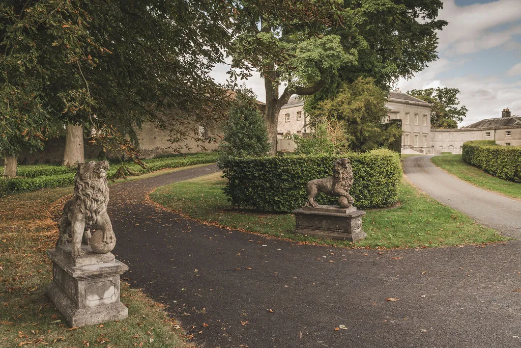 Stone lions flanking the estate avenue