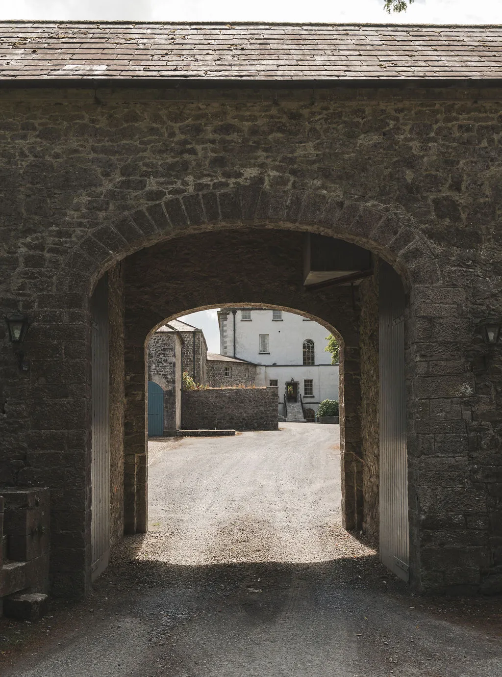 The stone gate arch leading into the stable courtyard