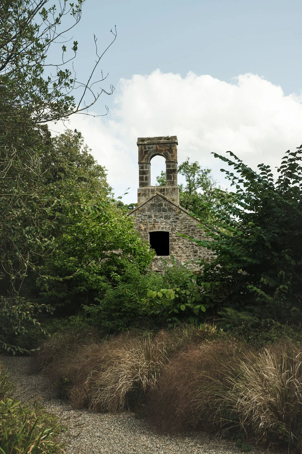 The bell tower of the old chapel rising from the trees of the estate