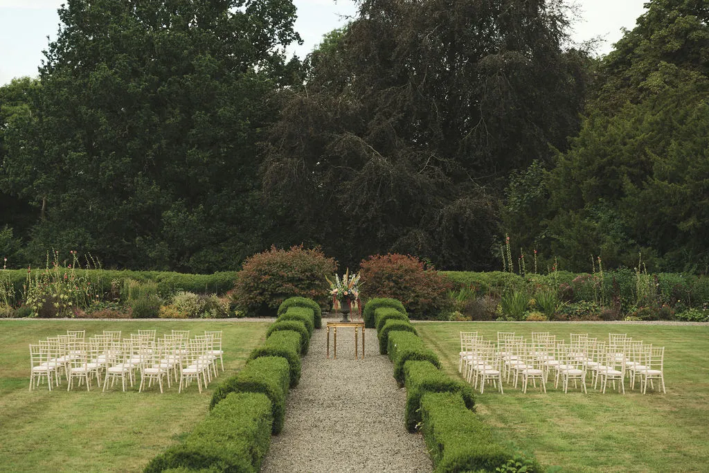 The walled garden ceremony, chairs arranged either side of a gravel aisle