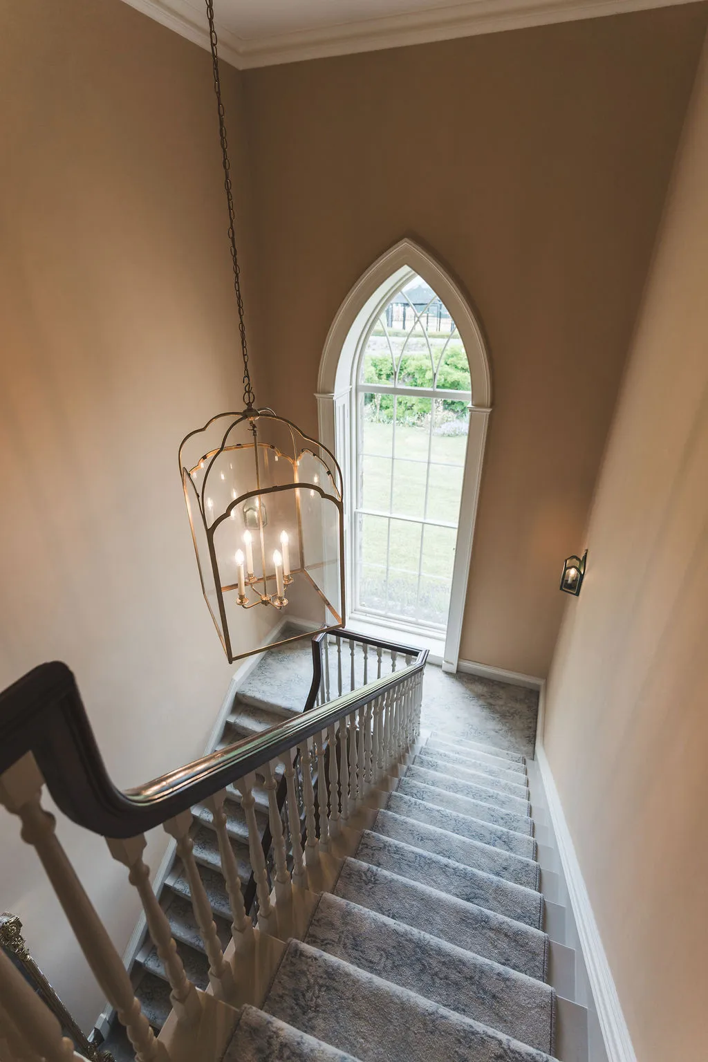 A gothic arched window above the wing staircase